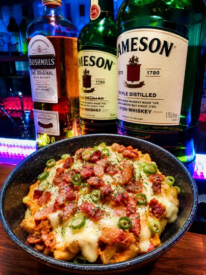 Irish nachos topped with cheese, bacon, and jalapeno