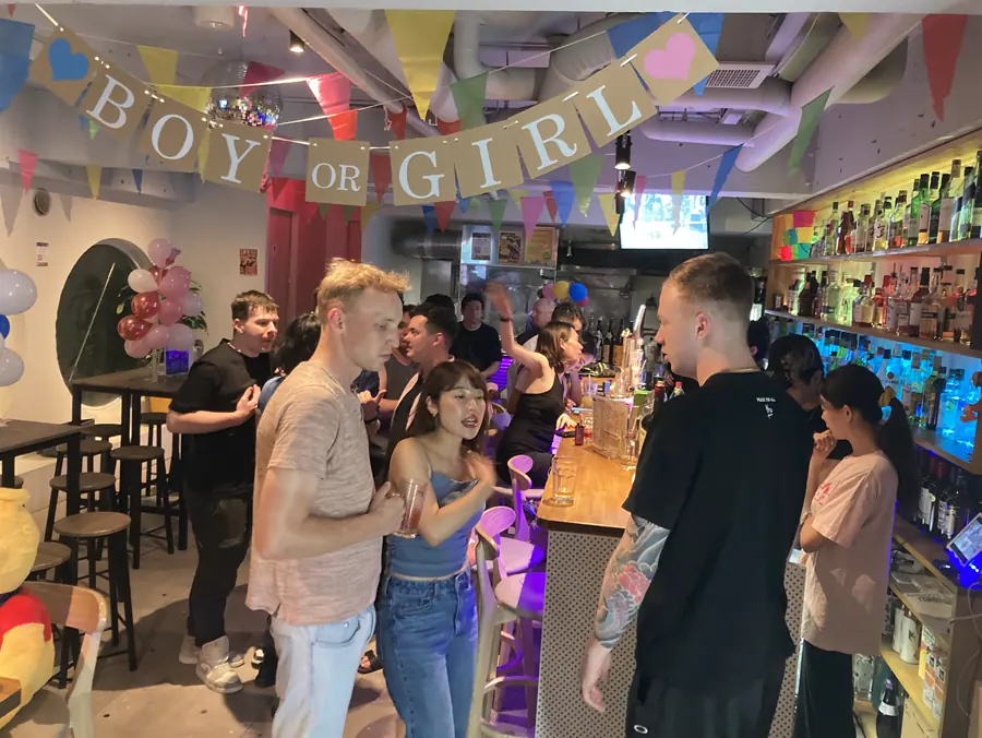 Friends celebrating together inside Friendz